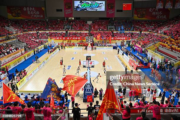 Players from Team Guangzhou in red and Team Shenzhen in white compete during the first leg of the semifinals of the 2026 Guangdong City Basketball...