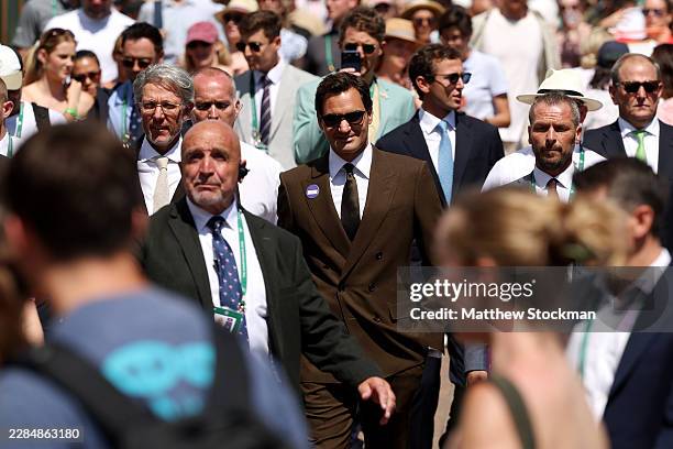 Former tennis player Roger Federer walks around the premises on day eight of The Championships Wimbledon 2026 at All England Lawn Tennis and Croquet...