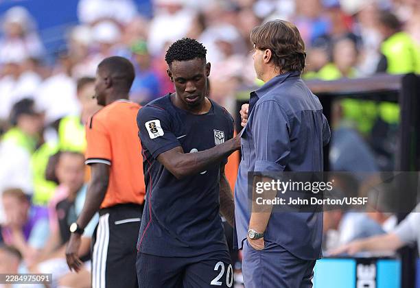Folarin Balogun of the United States shakes hands with Mauricio Pochettino, Head Coach of the United States, after being substituted during the FIFA...