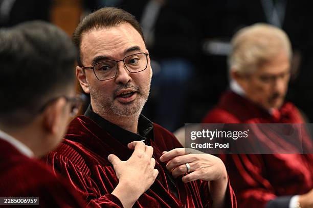 Senator Alan Cayetano talks to a fellow senator during the impeachment trial of Philippine Vice President Sara Duterte at the Senate of the...