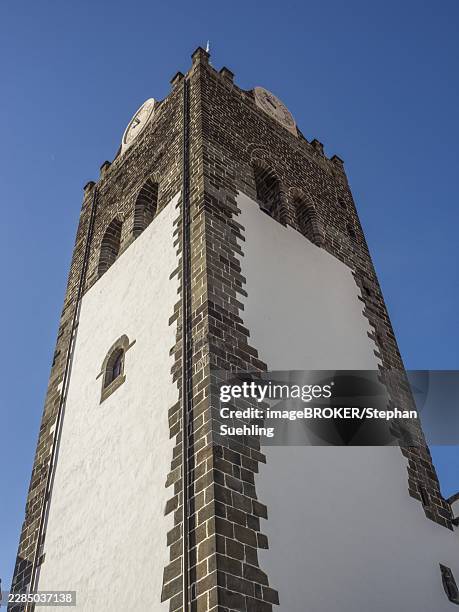high church tower with large clock in a white building, in front of a clear blue sky, funchal, madeira, portugal - funchal photos et images de collection