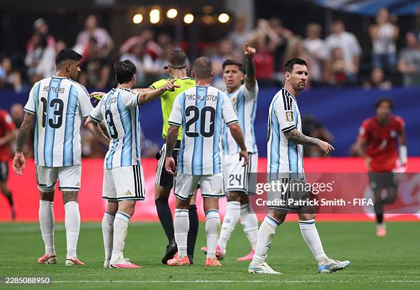 Lionel Messi reacts after conceding a second goal to Egypt while players of Argentina protest to Referee Francois Letexier for a possible foul,...