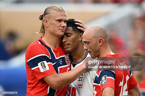Norway's forward Erling Braut Haaland congratulates England's midfielder Jude Bellingham as Norway's midfielder Fredrik Aursnes looks on, after...