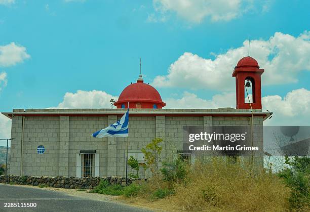 An Israeli flag is seen flying in front of the recently reconstructed Christian church dedicated to St. Peter on July 07, 2026 in the Lower Golan...