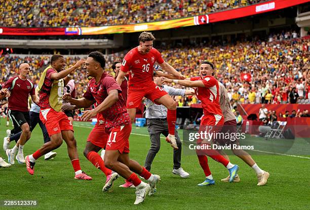 Ruben Vargas of Switzerland celebrates with teammates after scoring the fifth penalty in a penalty shootout for victory during the FIFA World Cup...