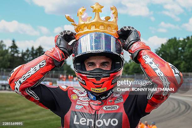 Ducati Lenovo Team's Spanish rider Marc Marquez celebrates with an inflatable crown after winning the race of the MotoGP German motorcycle Grand...