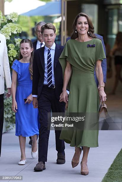 Catherine, Princess of Wales, Prince George and Princess Charlotte make their way to Center Court for the Gentlemen's Singles final match between...