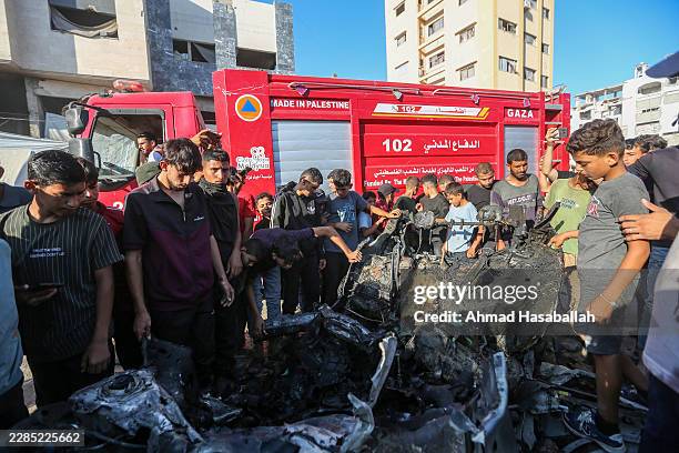 Civil defense personnel arrive to inspect a car that was destroyed by Israeli air strikes on July 8, 2026 in Gaza City, Gaza. Israel has continued to...
