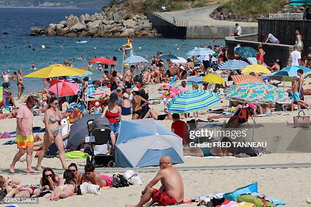 People enjoy the beach in Douarnenez, Brittany, on July 13 as France is weathering a third heatwave in less than three months.