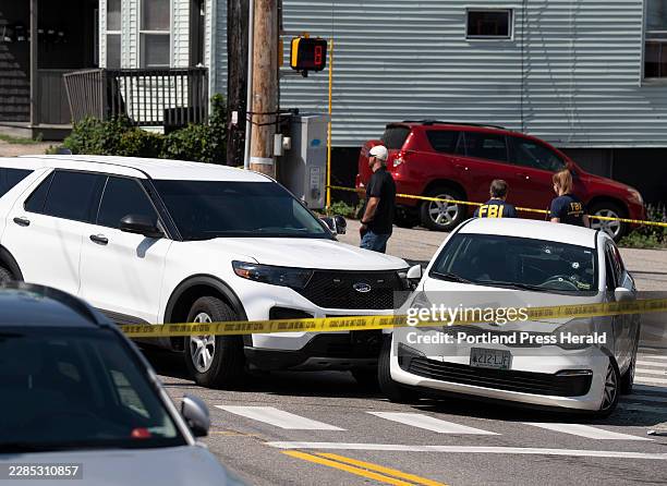 Kia sedan reportedly driven by the victim of a fatal shooting can be seen with four bullet holes in the windshield at the scene on Pool Street in...