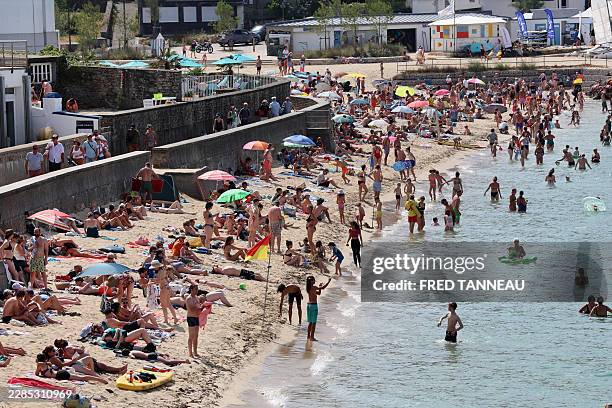 People enjoy the beach in Douarnenez, Brittany, on July 13 as France is weathering a third heatwave in less than three months.