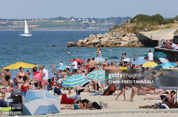 People enjoy the beach in Douarnenez, Brittany, on July 13 as France is weathering a third heatwave in less than three months.