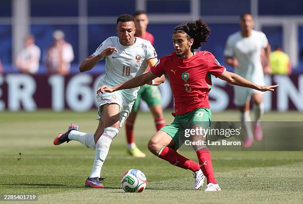 FOXBOROUGH, MASSACHUSETTS Ayyoub Bouaddi of Morocco controls the ball against Kylian Mbappe of France during the FIFA World Cup 2026 Quarter Final...