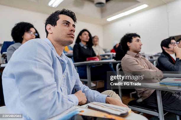 young man during lesson at university - mba students stock pictures, royalty-free photos & images