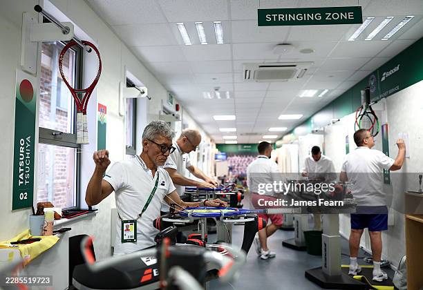 Technicians restring tennis rackets in a restringing room on day twelve of The Championships Wimbledon 2026 at All England Lawn Tennis and Croquet...