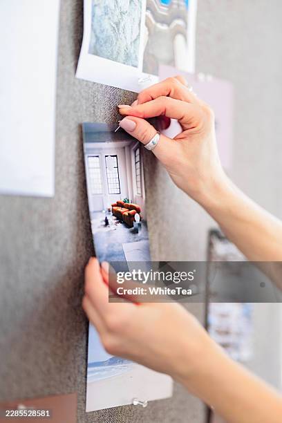 hands pinning photograph to inspiration mood board - pinching stock pictures, royalty-free photos & images