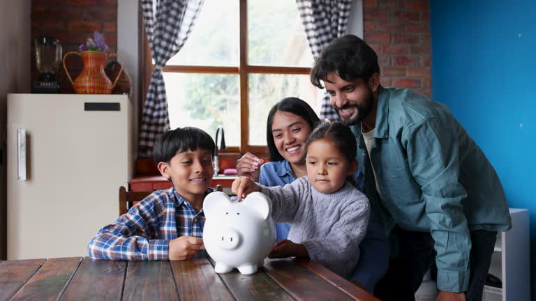 https://media.gettyimages.com/id/2285556219/video/family-saving-money-together-in-a-piggy-bank-all-taking-turns-to-insert-a-coin.jpg?b=1&s=640x640&k=20&c=lfsmyVZL5AwDIVfUY7AYDsp01albm8SwZ8Ks9rRQPDw=