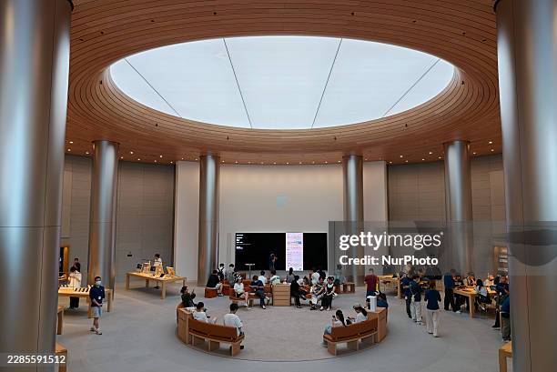 Customers interact with Apple products at the company's largest store in Asia in Shanghai, China, on July 15, 2026.