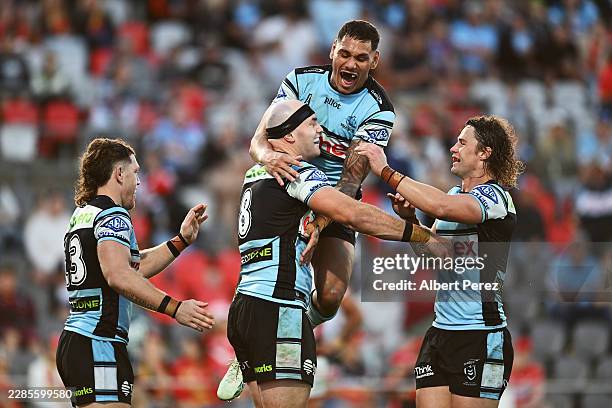 Thomas Hazelton of the Sharks celebrates with team mates after scoring a try during the round 19 NRL match between Dolphins and Cronulla Sharks at...