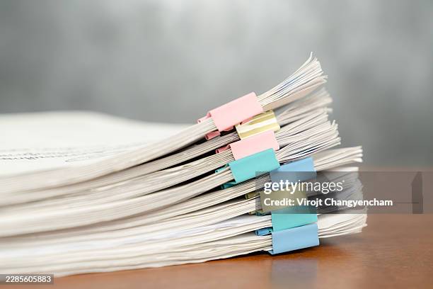 close-up of a large stack of documents on an office desk - folder structure stock pictures, royalty-free photos & images