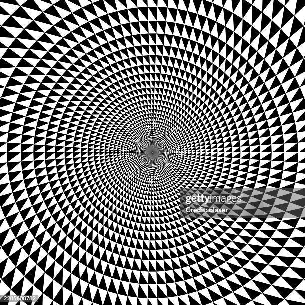 black and white geometric pattern of repeating triangular shapes spiraling inward toward a dense central point, creating a strong sense of radial movement and depth. - vortex tunnel stock illustrations