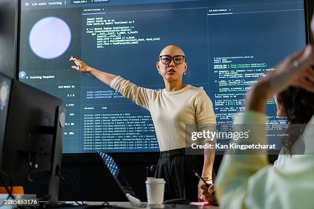 software developer presenting technical screen content while discussing project priorities, code quality, and development direction. - secure content management stock pictures, royalty-free photos & images