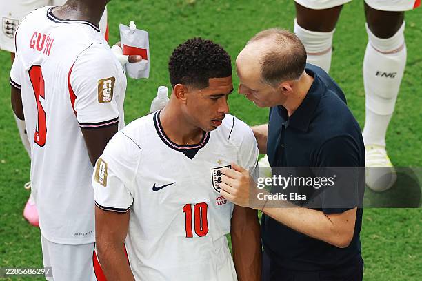 Thomas Tuchel, Manager of England, speaks with Jude Bellingham during a hydration break in the FIFA World Cup 2026 Quarter Final match between Norway...