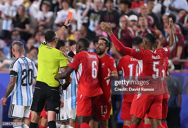Referee Joao Pinheiro shows a red card to Breel Embolo of Switzerland during the FIFA World Cup 2026 Quarter Final match between Argentina and...