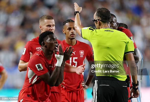 Breel Embolo of Switzerland argues with referee Joao Pinheiro following his second yellow card and subsequent red card during the FIFA World Cup 2026...