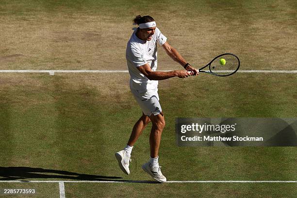 Alexander Zverev of Germany plays a backhand against Jannik Sinner of Italy during their Gentlemen's Singles final match on day fourteen of The...