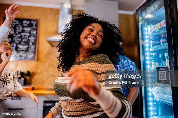 young friends dancing on kitchen at hostel - dance music stock pictures, royalty-free photos & images