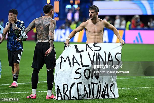 Giovani Lo Celso of Argentina holds a banner after the 2-1 win during the FIFA World Cup 2026 Semi Final match between England and Argentina at...