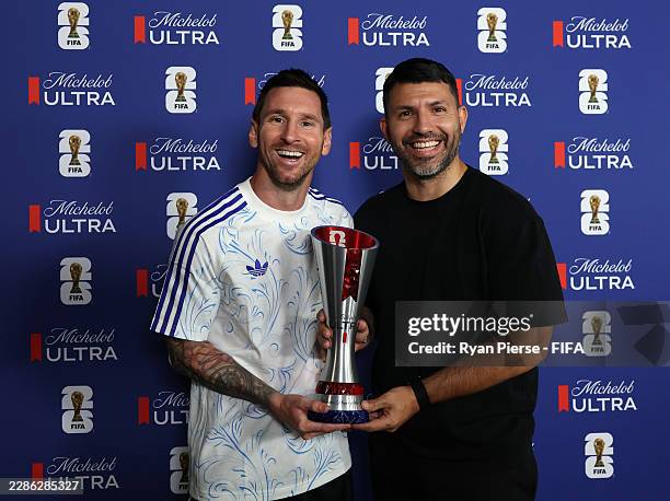 Lionel Messi of Argentina poses for a photograph with the Superior Player of the Match award alongside Sergio Aguero after the team's victory in the...