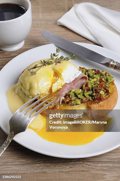 toasted baguette slice with guacamole, ham and eggs benedict under dutch sauce - ham cubes stock pictures, royalty-free photos & images