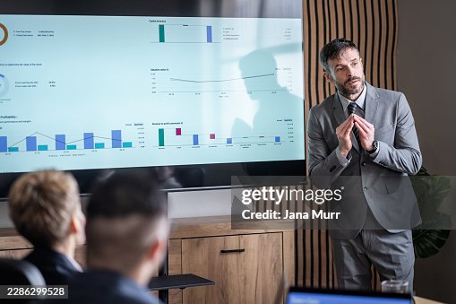 Business executive presenting data analysis on large screen Business executive presenting data analysis on large screen