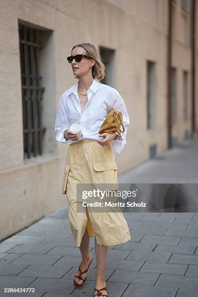 Marlies Pia Pfeifhofer is seen wearing black rectangular sunglasses from Jil Sander x Oliver Peoples; a Vita necklace from Daphine; a white cotton...