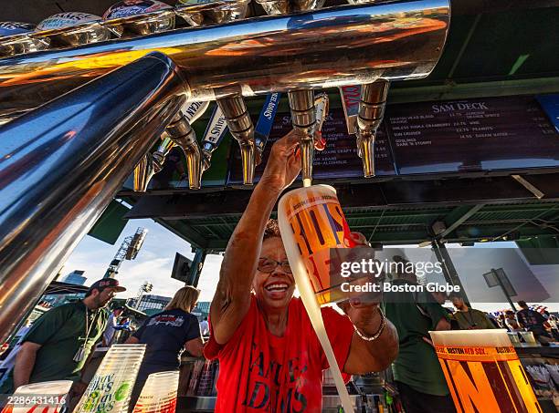 Bartender pours a beer at the Sam Adams Deck. The Boston Red Sox played the Tampa Bay Rays in the second game of a doubleheader at Fenway Park on...