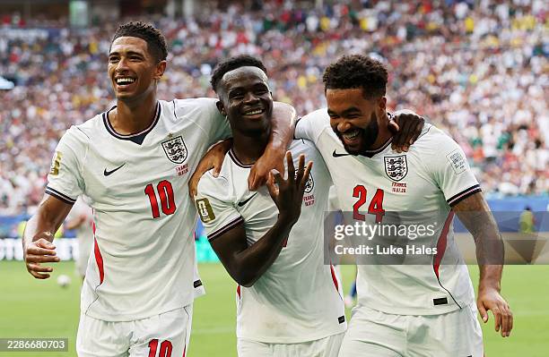 Bukayo Saka of England celebrates scoring his team's fifth and hat trick goal with teammates Jude Bellingham and Reece James during the FIFA World...
