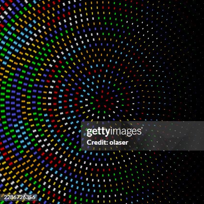 Colorful small rectangular lights form a circular spiral pattern on a black background, creating a dynamic radiating design with vivid rainbow hues and strong contrast. Colorful small rectangular lights form a circular spiral pattern on a black background, creating a dynamic radiating design with vivid rainbow hues and strong contrast.
