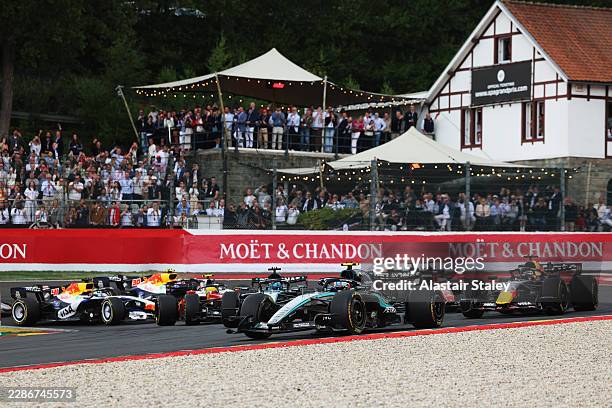 Andrea Kimi Antonelli of Italy driving the Mercedes AMG Petronas F1 Team W17 leads Max Verstappen of the Netherlands driving the Oracle Red Bull...
