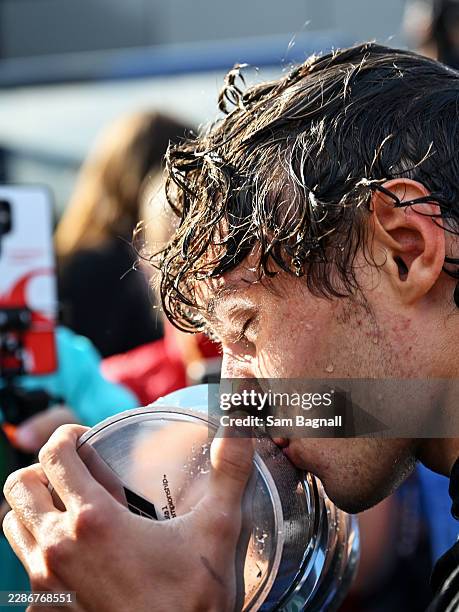 Race winner Andrea Kimi Antonelli of Italy and Mercedes AMG Petronas F1 Team kisses his trophy whilst celebrating with his team during the F1 Grand...