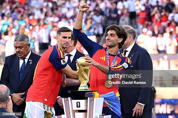 Ferran Torres of Spain celebrates with the FIFA World Cup Winner's Trophy after receiving his medal during the FIFA World Cup 2026 Final match...