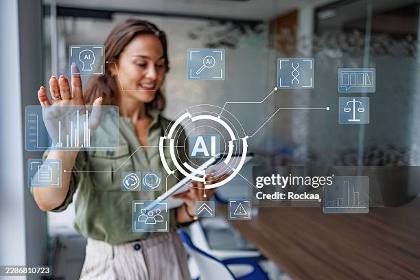 businesswoman interacting with ai interface, analyzing big data and innovative technology in a modern office - data engineer stock pictures, royalty-free photos & images
