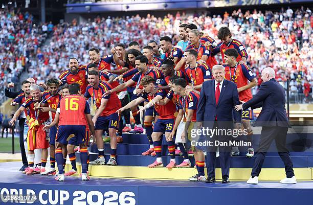 Rodri of Spain prepares to lift the FIFA World Cup Winner’s Trophy as FIFA President Gianni Infantino directs U.S. President Donald Trump after the...