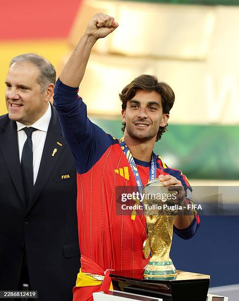 Ferran Torres of Spain celebrates with the FIFA World Cup Winner's Trophy after collecting his FIFA World Cup Winner's Medal after the FIFA World Cup...