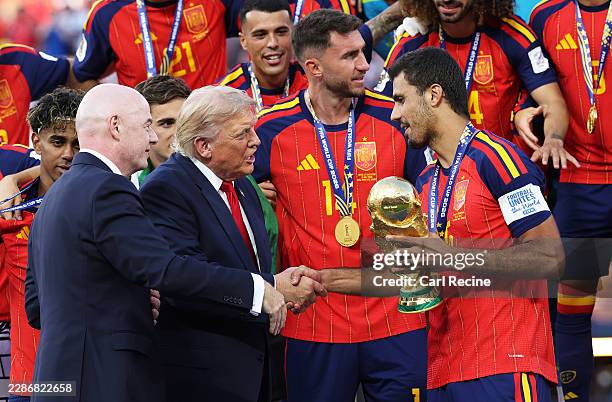 Rodri of Spain is presented the FIFA World Cup Winner’s Trophy by U.S. President Donald Trump and FIFA President Gianni Infantino after the team’s...