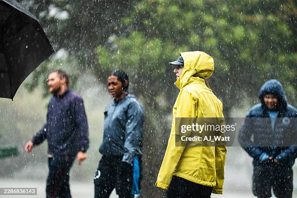 friends gathering in public park during heavy rain - rain storm stock pictures, royalty-free photos & images