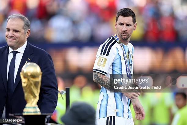 Lionel Messi of Argentina looks at the World Cup trophy after losing the FIFA World Cup 2026 Final match between Winner Spain and Argentina at New...