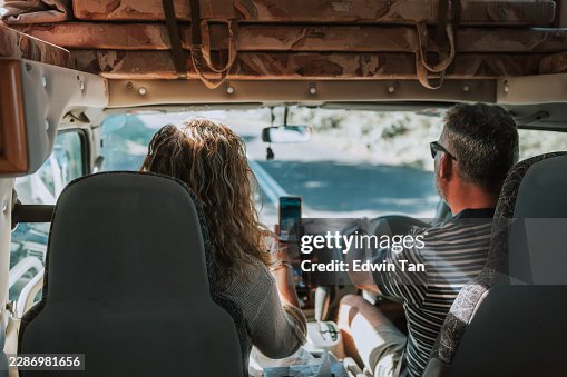 Generation X White Couple Using Smartphone Navigation App Inside camper van on Byron Bay Hinterland Road Trip Generation X White Couple Using Smartphone Navigation App Inside camper van on Byron Bay Hinterland Road Trip