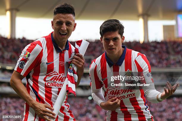 Roberto Alvarado of Chivas celebrates after scoring the team's first goal with teammate Jonathan Perez during the 2nd round match between Chivas and...